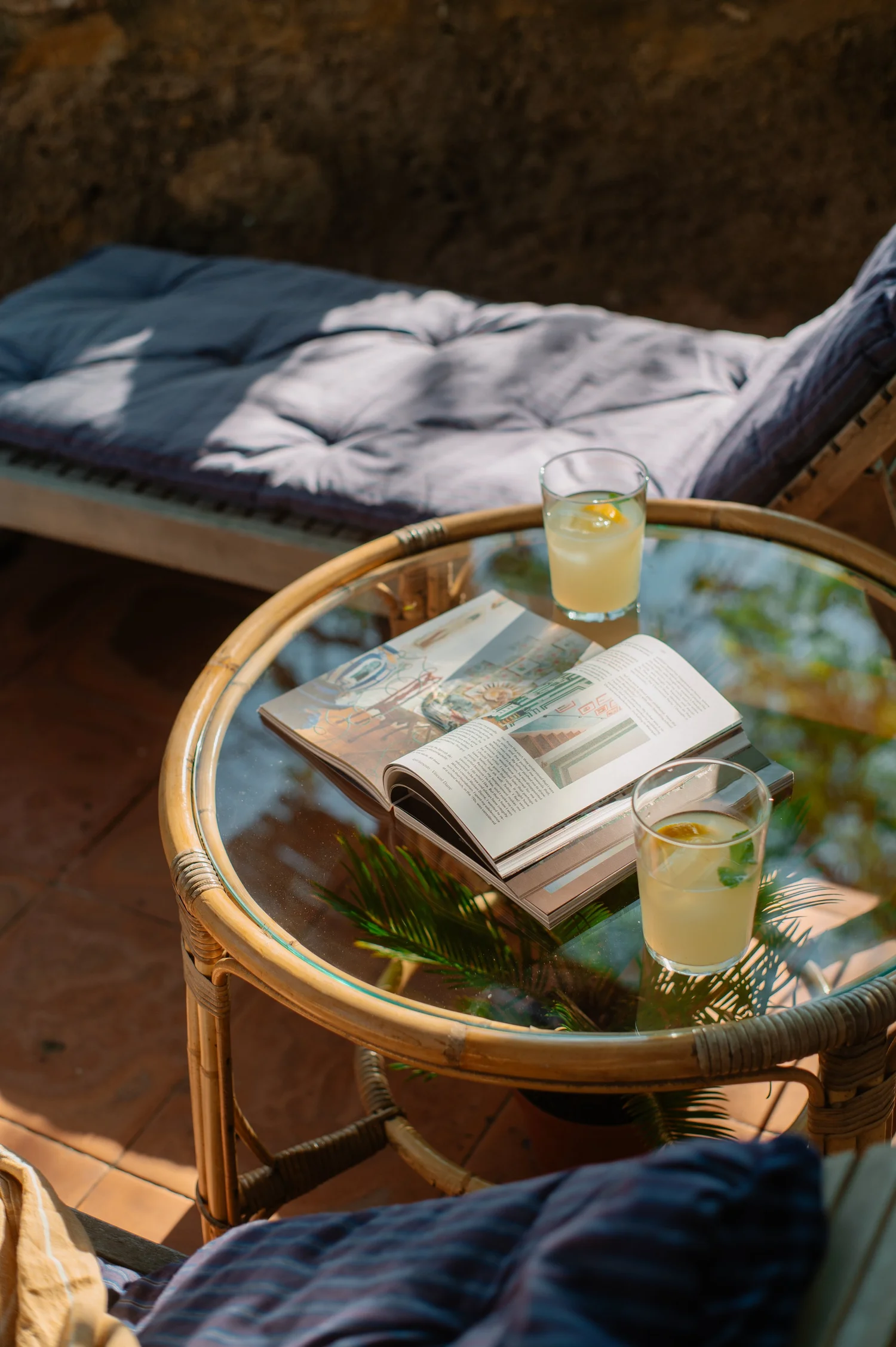 Rattan side table on the terrace with an open magazine